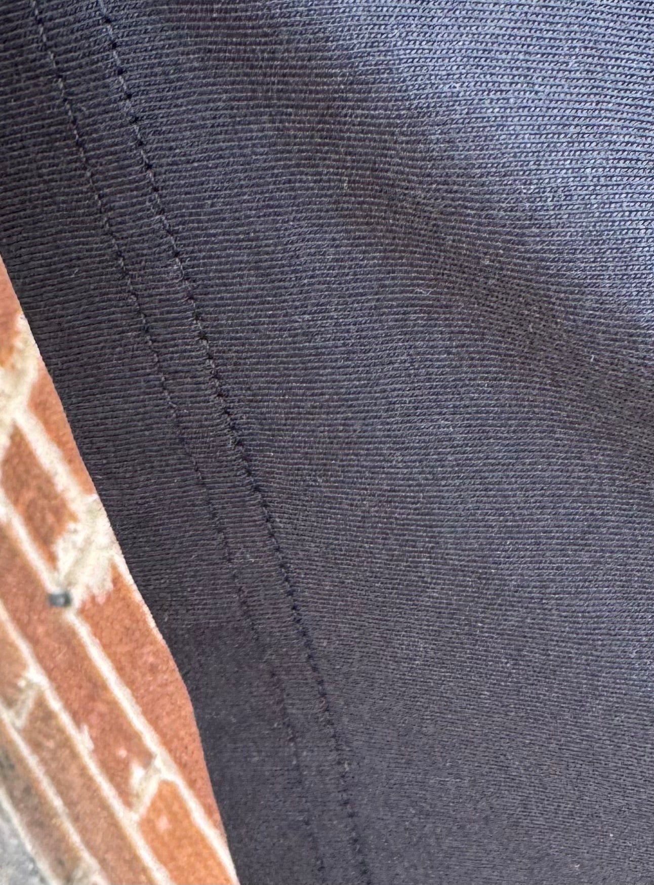 Close up of quality, reinforced stitching on Steel City Tough origin T-shirt.